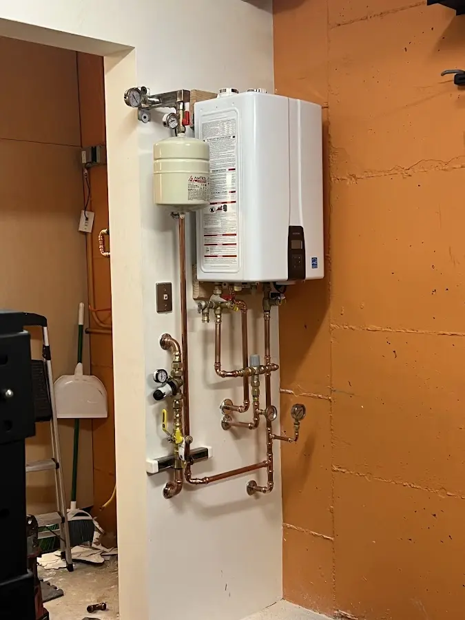 Plumbing technician inspecting water heater connections in Chula Vista